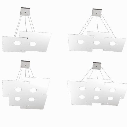 Collezione di lampade a plafone ed a sospensione realizzate con lastre in metallo verniciato bianco in diverse forme.